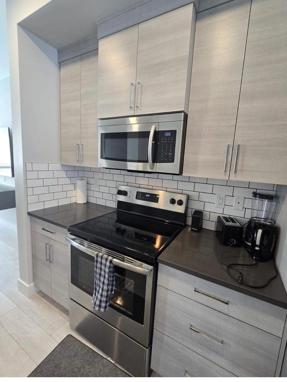Finished kitchen refresh with stainless steel appliances and subway tile backsplash